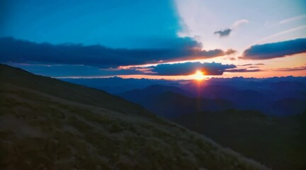 Poster - A sunrise time-lapse over a peaceful mountain range.
