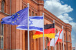 The European, Israeli, German and Berlin flags blow in the wind in front of the Berlin town hall 