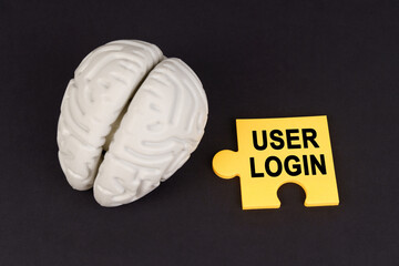 Poster - On a black surface lies a brain and a yellow puzzle with the inscription - User login