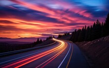 A long exposure photo of the road on the highway at a sunset