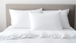 © Barosanu - comfortable clean white bed with duvet and soft sheets in bright room with pillows