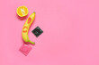Fresh banana with lipstick kiss, orange and condoms on pink background. Sex education concept