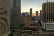 © bilanol - Evening urban landscape of downtown district of Miami Brickell in Florida USA. Skyline with dark high skyscraper buildings and street with cars and Metrorail traffic in modern american megapolis