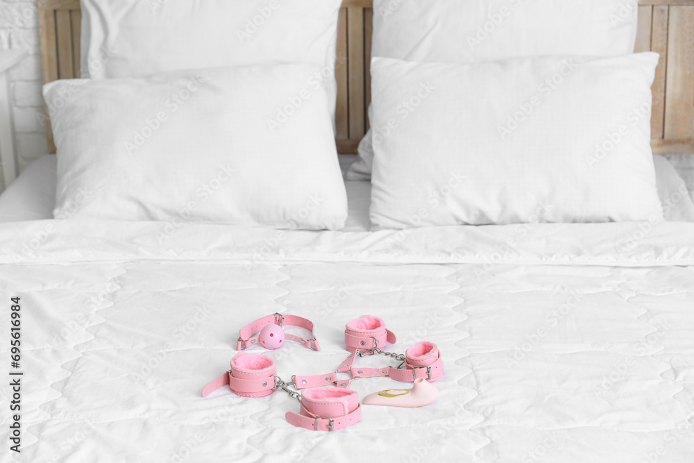 Sex toys on bed in room