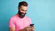 © Studio Nova - Man smiling and holding her smartphone on a blue background