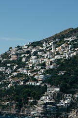 Wall Mural - Amalfi Sea Coast with Umbrellas, people swim, and Yachts. Clean and blue sea where to swim. Photo for tourism and summer background. Concept of vacation and beach life in the open air   colorful