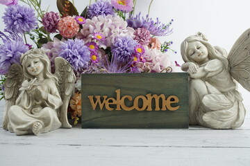 Poster - Welcome sign with flowers bouquet and angel statues home decorations