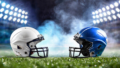 Sticker - American football helmets facing each other on football field with stadium lights. Sports background