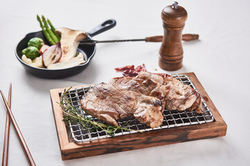 Wall Mural - Pork neck that is deliciously grilled on a white background and golden brown on a brazier