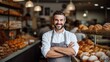 © CStock - business owner smiling at the camera with bakery shop background,