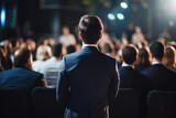 Fototapeta  - a man in a suit standing in front of a crowd