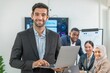 © BESTIMAGE - businessman leader supervisor and manager smile and carry hold notebook tablet in office company. leader senior manager looking and carry laptop in meeting room multiracial teamwork background.