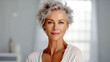 Elegant mature lady with gray hair - With perfectly smooth - Well-groomed skin - Relaxing in the spa