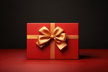 Poster - A red gift box with a gold bow. Perfect for any special occasion or holiday gift giving