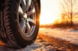 A close up view of a tire on a snowy road. Suitable for winter driving or road safety concepts