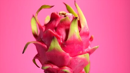 Wall Mural - Dragon fruit, Pitahaya, Pitaya exotic asian vegan juicy fruit close up. Rotating over pink background. Slow motion. Healthy vegan Thai food.