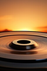 Aufkleber - A close-up view of a disc with a stunning sunset in the background. This image can be used to represent nature, beauty, serenity, or the passing of time