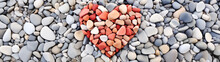 Orange And Red Pebbles In The Shape Of A Heart On A Background Of Gray Pebbles, Valentine's Day Background