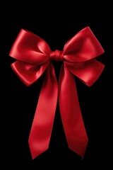 Poster - A simple yet striking image of a red bow on a black background. Perfect for adding a pop of color to any design.