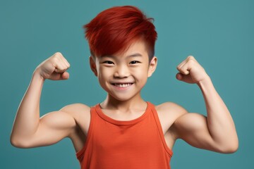 Poster - A young boy with red hair showing off his strong muscles. Perfect for fitness or health-related content