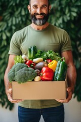 Aufkleber - A man holding a box full of fresh vegetables. Perfect for food and nutrition-related projects