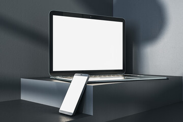 Poster - Close up of empty white laptop and smartphone on dark gray desk. Concrete wall background, shadows and pedestal or podium. Device presentation and online education concept. Mock up, 3D Rendering.