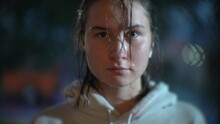 Teenage Girl With Wet Face And Hair Looking In Camera At A Rainy Night. Closeup Portrait.