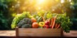 Wooden box filled with freshly harvested vegetables with sunlights shimmering and creating a defocused effect.