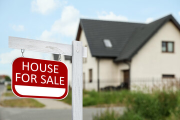 Sticker - Sale sign near beautiful house outdoors. Red signboard with words