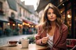 A young European woman sipping coffee in a quaint street café.
