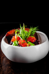 Wall Mural - Layered salad with salmon, beets, carrots, onions, potatoes and eggs on a plate.