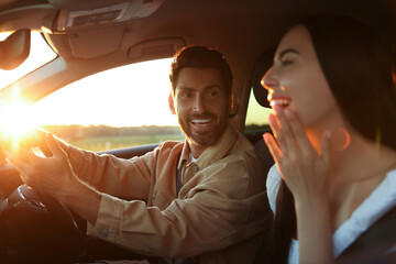 Happy couple enjoying trip together by car, selective focus