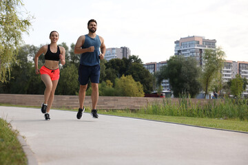 Poster - Healthy lifestyle. Happy couple running outdoors, space for text