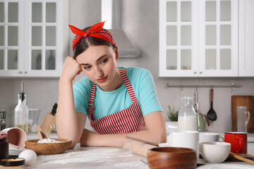 Canvas Print - Upset housewife at messy countertop in kitchen. Many dirty dishware, food leftovers and utensils on table