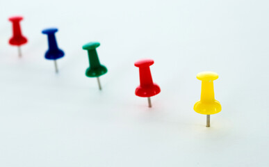 Push pins in a row isolated on white