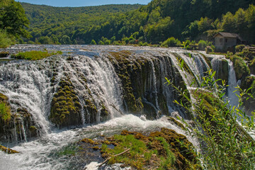 Wall Mural - Strbacki Buk, a terraced waterfall on the Una River on the border between the Federation of Bosnia and Herzegovina and Croatia. Early September