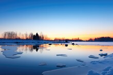 Blue Hour Glow Over A Serene, Ice-bound Lake
