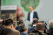 © Microgen - A captivated audience sits attentively, engrossed in a dynamic green energy seminar.