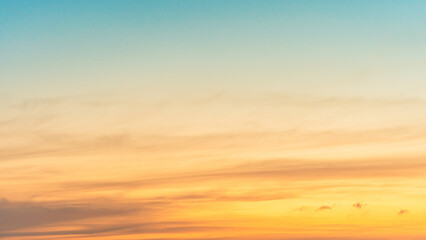 Wall Mural - morning horizon sky with orange, yellow sunrise clouds, golden hour and bright sunlight background