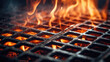 Macro close-up of a flaming black grill, with fire, smoke and fire sparks. Metal grill for grilling meat and food at an outdoor picnic.