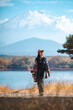 © chokniti - Happy tourist traveler woman or man enjoying on lake kawaguchiko with mount fuji in japan, spring and summer, Japan travel vacation site