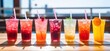 © ArtCookStudio - line up of iced drinks with straws in small cups