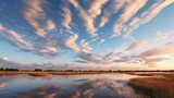 Fototapeta Niebo - blue sky and clouds reflecting on a marsh at sunset