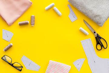 Frame of sewing accessories on fashion designer dressmaker table