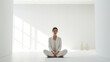 Concept of Digital Detox. Woman in Serene White Room. A woman stands in a sparse white room, symbolizing the concept of digital detox and disconnection for mental clarity.