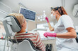 © Soloviova Liudmyla - Dentist doctor examination Dental X-rays scan. Dental clinic patient visit modern medical ward. Female sitting in comfortable chair. Health care, medicare industry, heathcare technology concept image