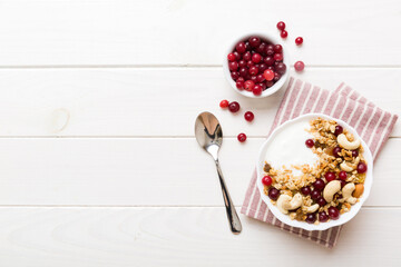 Wall Mural - Healthy breakfast food with granola, yogurt, fruits and nuts. Dessert parfait with dried fruits for breakfast