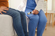 Cropped photo of professional doctor neurologist examining patient knocking on knee with hammer to test knee jerk patellar reflexin in medical clinic closeup. Neurology, medical checkup concept.