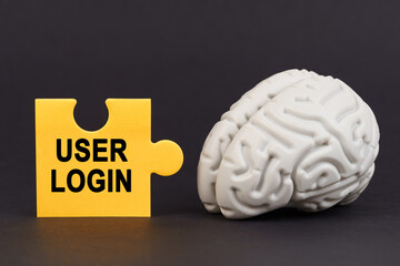 Poster - On a black surface there is a brain and a yellow puzzle with the inscription - User login