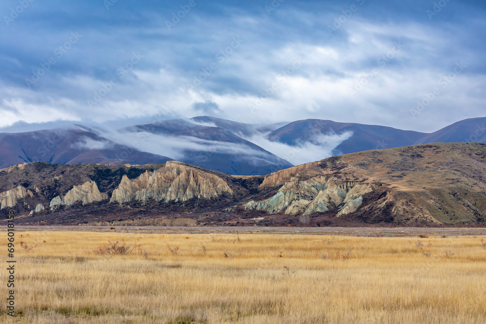 Large Brown Ridge Photograph of an usual looking rock structure in a brown field in front ...
